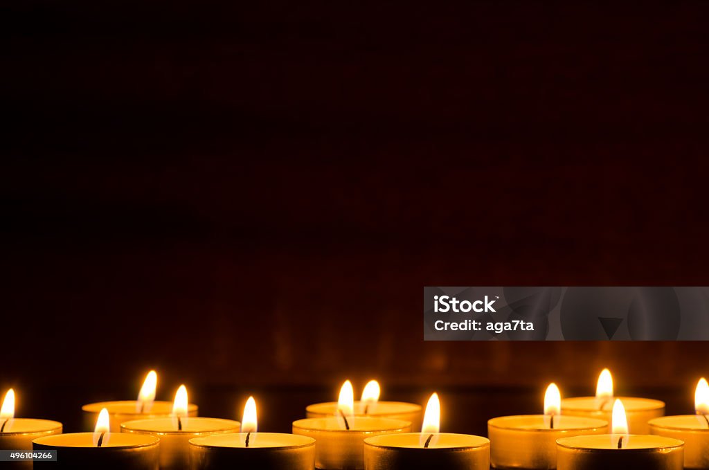 burning candles in darkness closeup to burning candles in darkness Candle Stock Photo