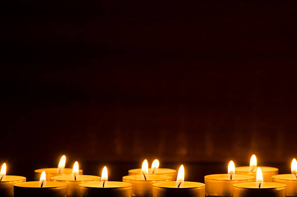 burning candles in darkness stock photo