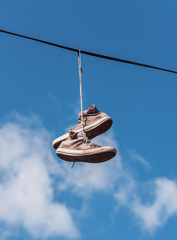 old sneakers (shoes) on a wire