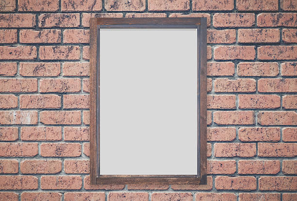 istock Brown wood picture frame on red brick wall 496106786