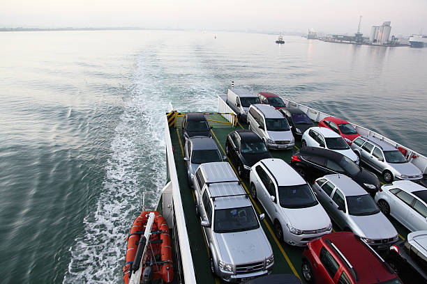 Ardrossan, Scotland, UK- August 6, 2011: Motor vehicles on the car deck of a roll-on, roll-off ferry (MV Saturn) leaving Ardrossan towards Brodick, Isle of Cumbrae. They are mostly family cars with two 'white vans' and a 4x4.
