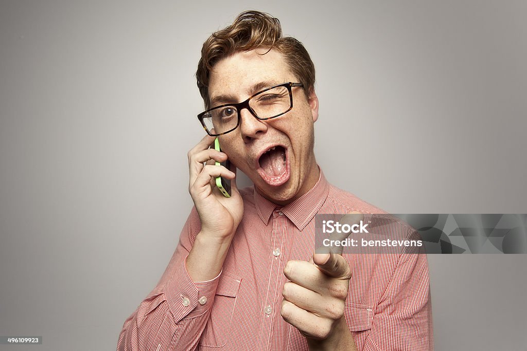 Nerd on the Phone A nerd on the phone, pointing and winking  Humor Stock Photo