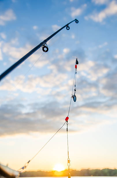istock fishing on a lake before sunset 496113919
