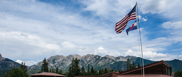 Colorado Flag with American Flag Rocky Mountain Landscape. Epic Back ground with Jagged Rocky Mountains from the San Juan Mountain Range near Durango and Silverton Colorado. The Heart of the Rockies. 