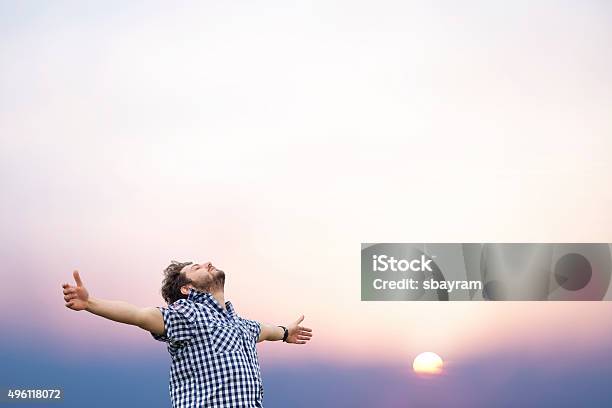 Young Man With Arms Raised Stock Photo - Download Image Now - Men, Praying, Mental Health