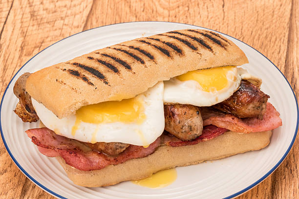 istock Breakfast Panini with bacon, sausages and fried eggs 496119218