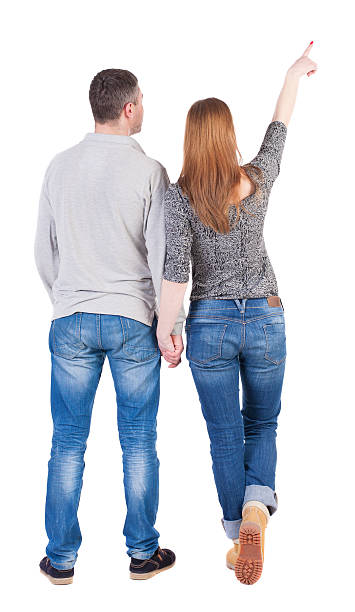 istock young couple pointing at wal Back view 496119540