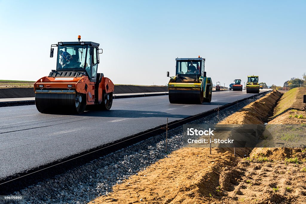 New road construction Road rollers building the new asphalt road Road Construction Stock Photo