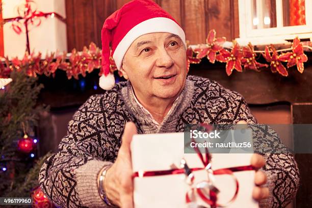 Mature Man Holding A Red Christmas Gift Box Stock Photo - Download Image Now - 2015, Achievement, Adult