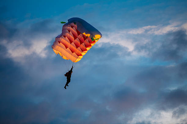 istock Skydiver On Colorful Parachute In Sky 496122524