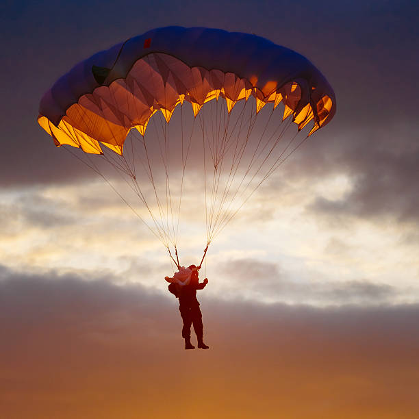 istock Skydiver On Colorful Parachute In Sunny Sky 496122570