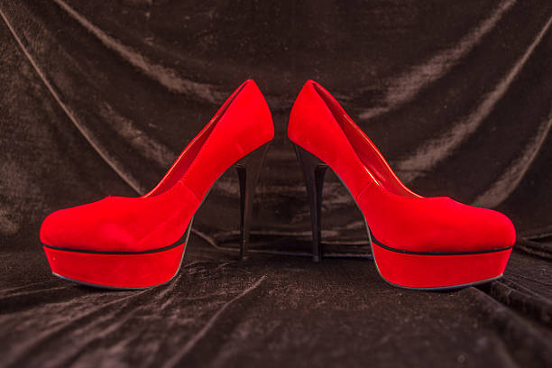 istock Women's red shoes isolated on black background 496123002