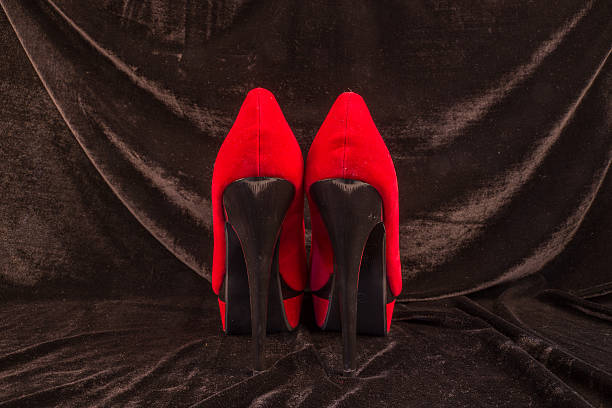 istock Women's red shoes isolated on black background 496123248