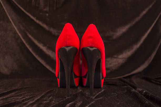 istock Women's red shoes isolated on black background 496124090