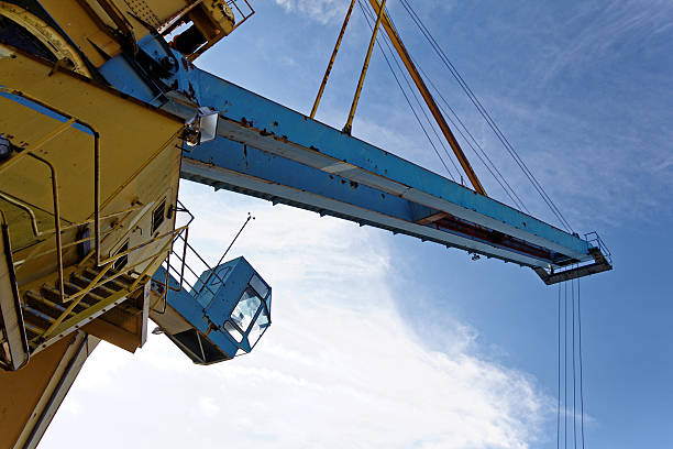 harbor crane detail of a crane against blue sky level luffing crane stock pictures, royalty-free photos & images
