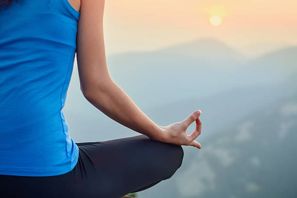 istock Woman meditating in the nature on sunset 496127400
