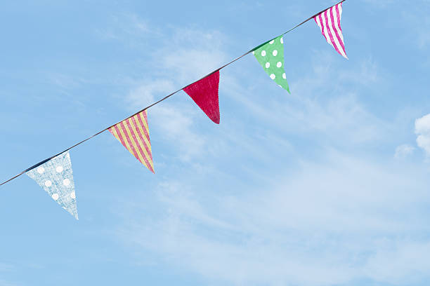 istock Photo of fabric bunting, flags, over slue sky with clouds. 496128006