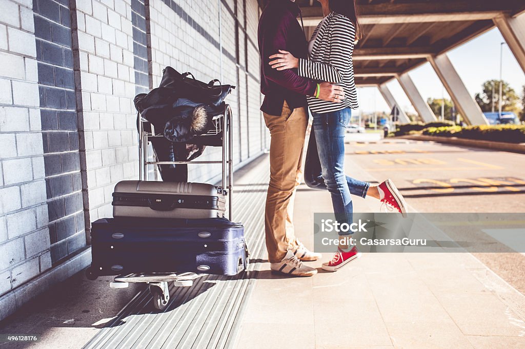Young Couple Exploring the City Young couple kissing outside airport Airport Stock Photo