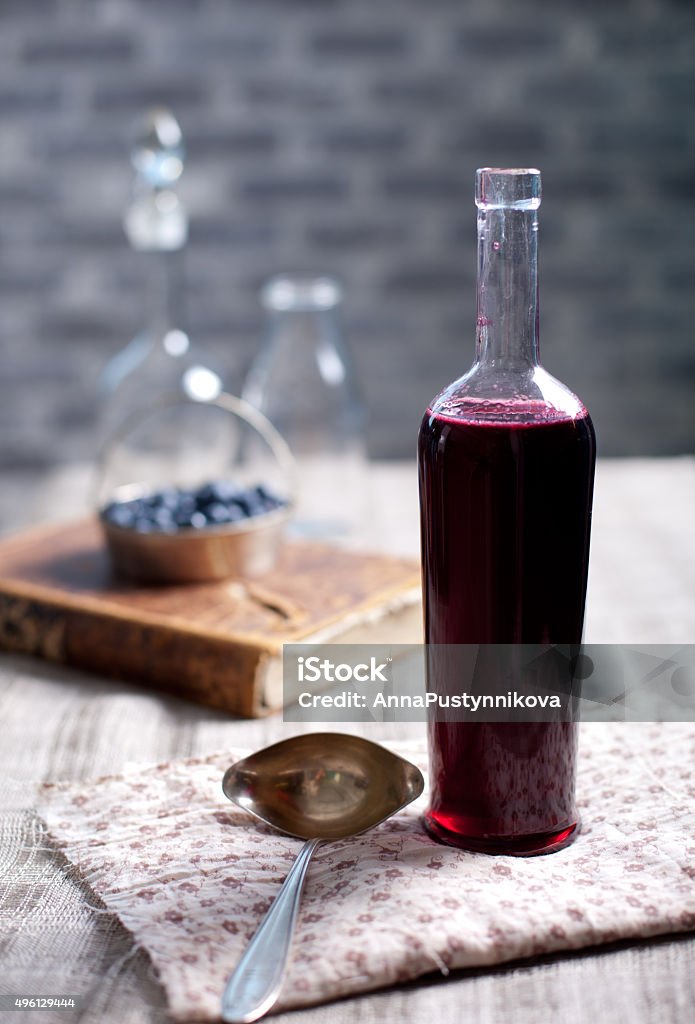 Vintage wine bottle with homemade blackcurrant, blueberry and blackberry vinegar. Old, vintage wine bottle with homemade blackcurrant, blueberry and blackberry vinegar. 2015 Stock Photo