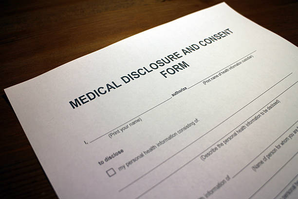 istock Filling out Medical Disclosure and Consent Form 496153050