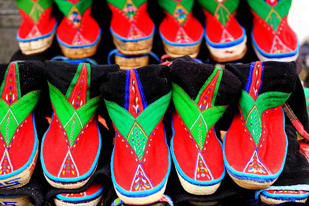 Traditional footwear. Shigatse-Tibet. 1781 Many colored traditional tibetan fabric shoes for men. Stall of the market in Shigatse city-county and prefecture. Tibet A.R.-China. shoe mold stock pictures, royalty-free photos & images