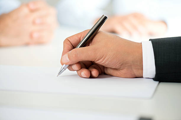 istock Man Signing Contract Paper 496154578