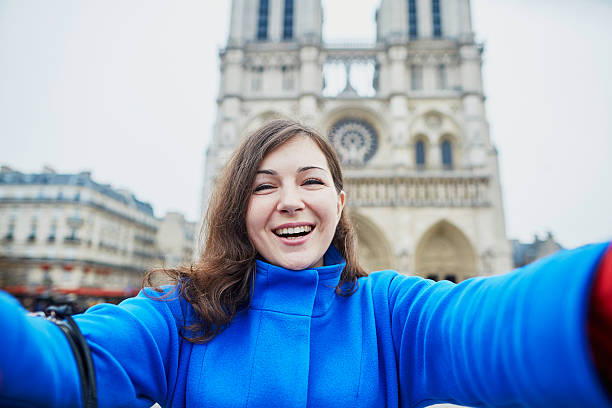 istock Beautiful tourist in Paris on a fall day, making selfie 496155138