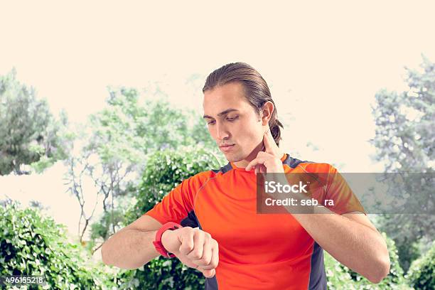 Sports Man Checking Pulse Stock Photo - Download Image Now - 2015, Adult, Adults Only