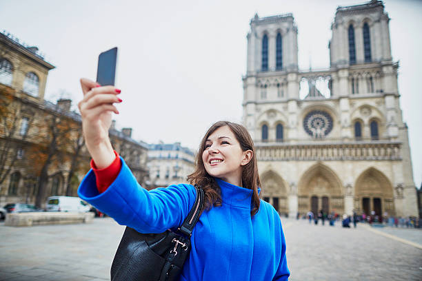istock Beautiful tourist in Paris on a fall day, making selfie 496155296