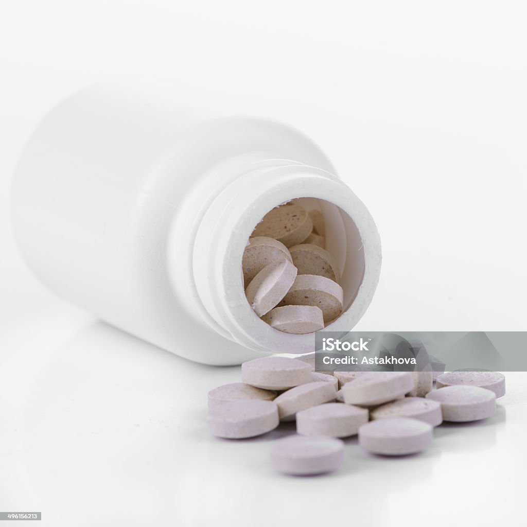 tablets with container pharmacology. vitamins and tablets with container. isolated on white background Abuse Stock Photo