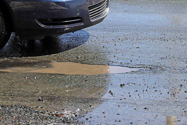 istock Car Ready To Hit A Pothole On A City Street 496157248