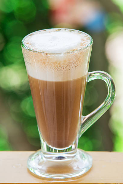istock coffee with pattern in a white cup on wooden background 496157569