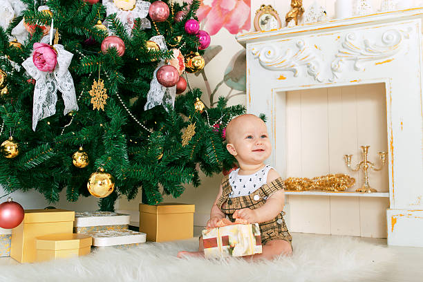 istock child with gift Christmas tree smiles 496158772