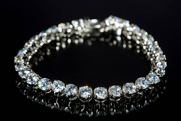 istock golden bracelet with precious stones on black background 496160526