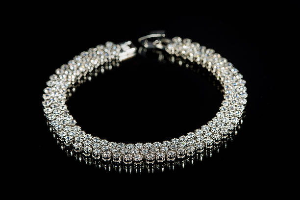 istock golden bracelet with precious stones on black background 496160570