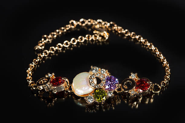 istock golden bracelet with precious stones on black background 496160646