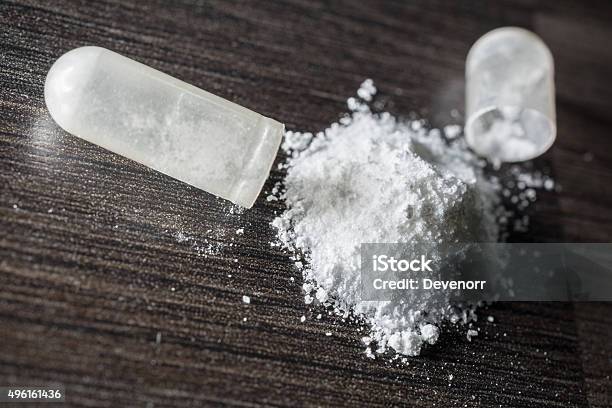 Macro Of An Opened White Medicine Capsule Stock Photo - Download Image Now - White Color, Talcum Powder, Capsule - Medicine