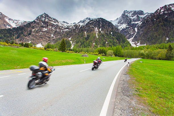 Motorcyclists ride the Maloja pass Motorcyclists ride the Maloja pass, Alps, Switzerland. maloja region stock pictures, royalty-free photos & images