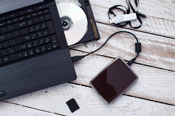 istock Laptop with pendrive, sd card, CD and portable hard drive. 496163378