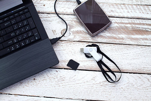 istock Laptop with pendrive, sd card, CD and portable hard drive. 496163428