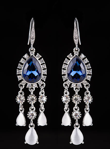 istock earring with colorful blue gems on black background 496163458