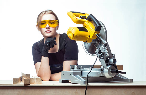 istock woman with a circular disk saw 496163472
