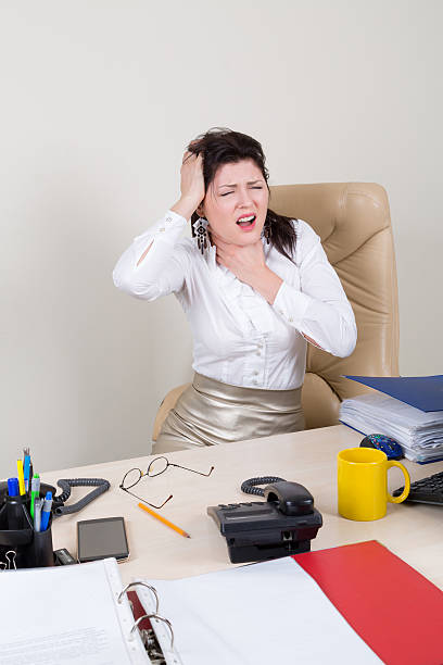 istock overworked woman with pain in office 496163484