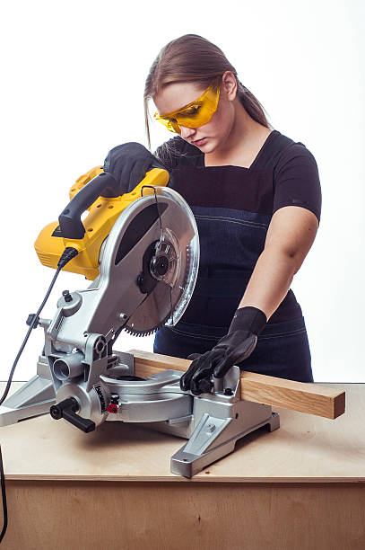 istock woman with a circular disk saw 496163512