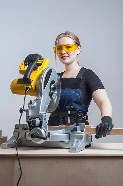 istock woman with a circular disk saw 496163950