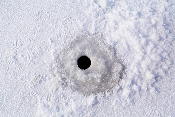 ice fishing hole on clear ice