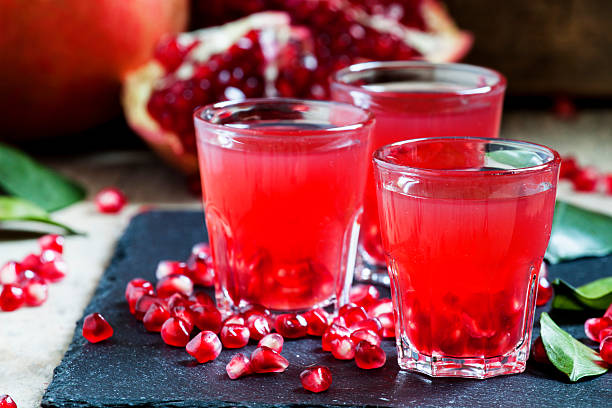istock Fresh pomegranate juice on a black background 496164932