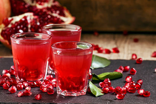 istock Fresh pomegranate juice on a black background 496165040