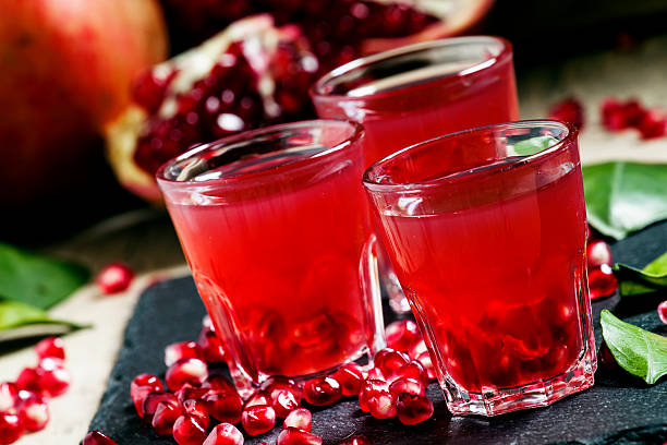 istock Fresh pomegranate juice on a black background 496165304