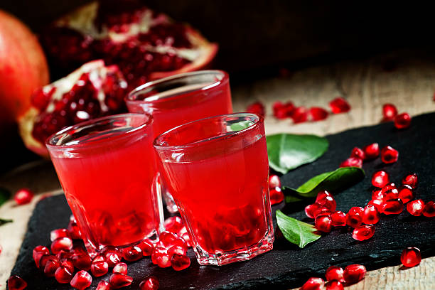 istock Fresh pomegranate juice on a black background 496165424